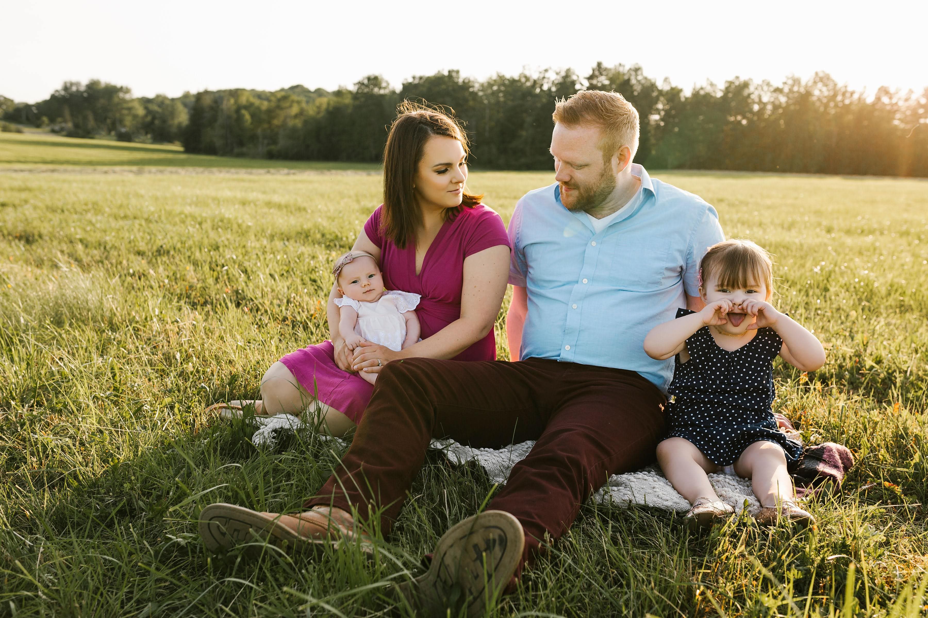 Photo of the Marshall family in the grass at the golden hour